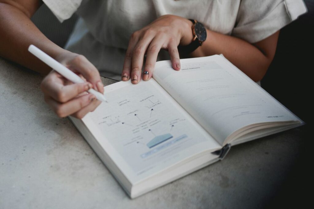 Close up of a person writing a plan into a diary